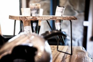 viking helmet and drinking horns on solid wood table